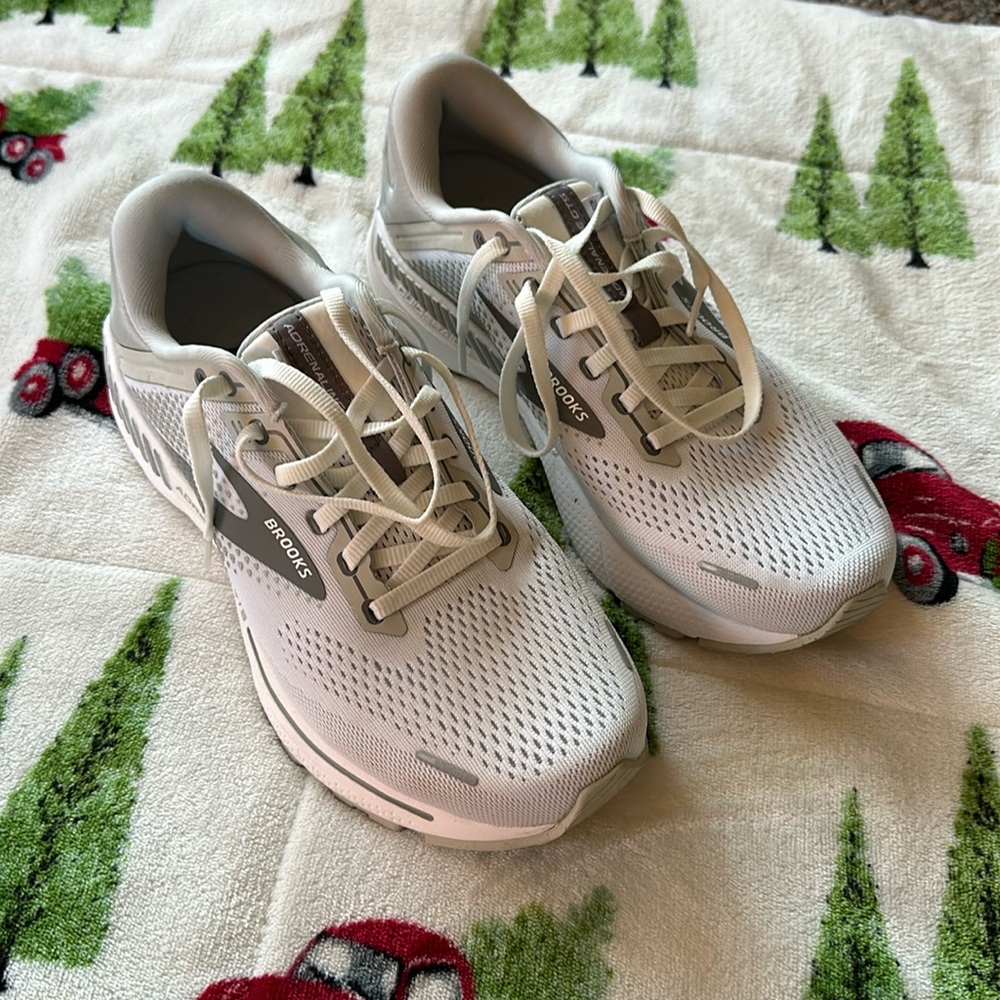 Women’s white and grey Brooks tennis shoes.